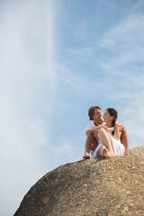 Poster - Couple relaxing on rock formation