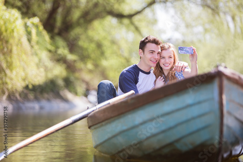 Fotografía Couple taking self-portraits in rowboat