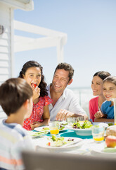 Wall Mural - Family eating lunch on sunny patio