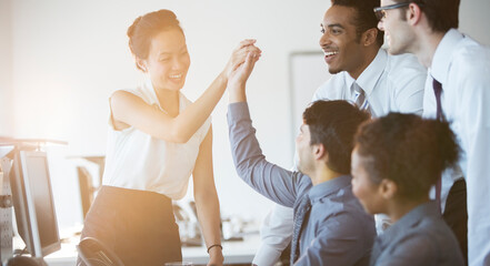 Business people cheering in office