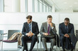 © Chris Ryan/KOTO - Businessmen sitting in waiting area