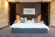 © Astronaut Images/KOTO - Lamps and wall art in modern bedroom
