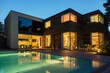 © Astronaut Images/KOTO - Modern house and swimming pool illuminated at dusk