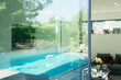 © Astronaut Images/KOTO - Swimming pool reflected in glass windows of modern house
