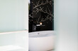 © Astronaut Images/KOTO - Wall art above soaking tub in modern bathroom