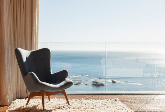 chair in sunny window overlooking ocean