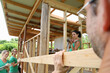 © Gift Culture Media/KOTO - People building wooden house frame together