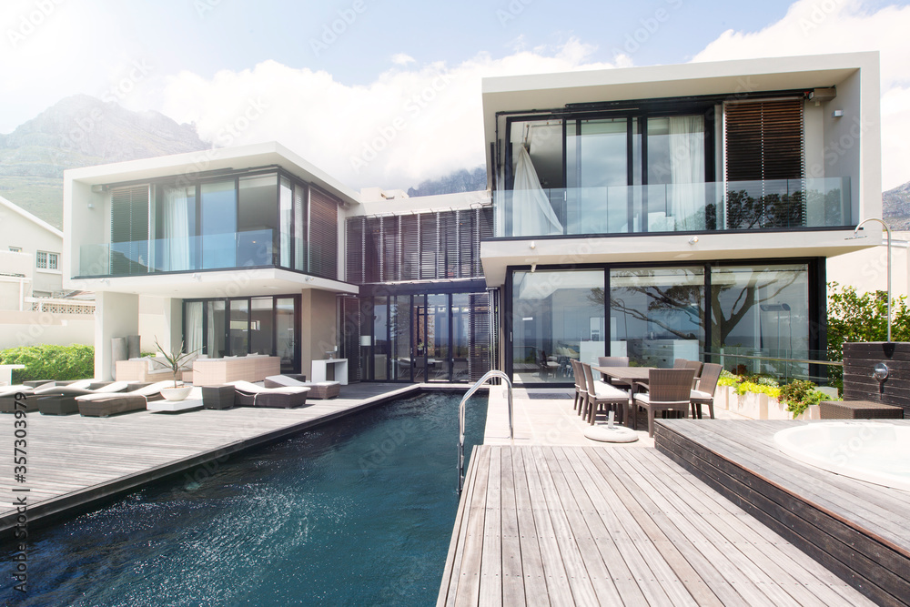 Modern house with large patio and swimming pool - obrazy, fototapety, plakaty 