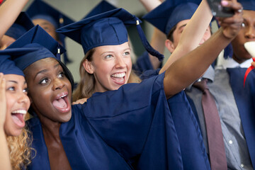 Wall Mural - University students taking selfie after graduating