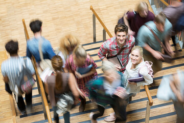 Students looking at camera and standing on stairs during break time