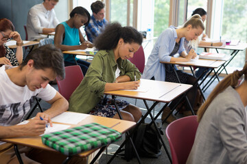 University students taking exam in classroom