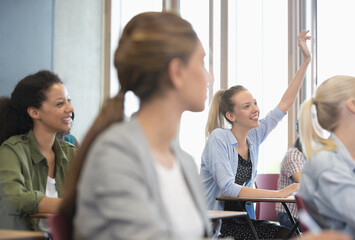 Wall Mural - View of smiling female students sitting at desks in classroom 