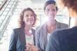© Sam Edwards/KOTO - Three smiling businesswomen talking in office corridor