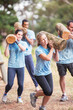 © Sam Edwards/KOTO - Determined people running with logs on boot camp obstacle course