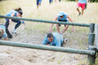 © Sam Edwards/KOTO - People crawling under net on boot camp obstacle course