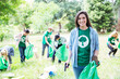 © Robert Daly/KOTO - Portrait of smiling environmentalist volunteer picking up trash