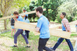 © Robert Daly/KOTO - Volunteers carrying wood planks