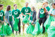 © Robert Daly/KOTO - Smiling environmentalist volunteers picking up trash