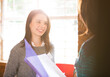 © Martin Barraud/KOTO - Smiling businesswomen with paperwork in meeting