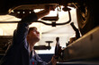 © Trevor Adeline/KOTO - Mechanic working under car in auto repair shop