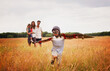 © Paul Bradbury/KOTO - Playful boy with wings in aviator cap and flying goggles in field