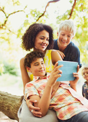 Multi-generation family using digital tablet outdoors