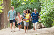 Multi-generation family walking in woods
