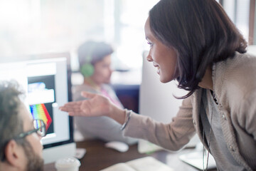 Wall Mural - Creative businesswoman gesturing at computer in office