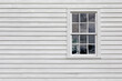 Old Single Pane Window in an Exterior Wall with White Siding