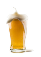 glass of lager beer with overflowing foam on white background