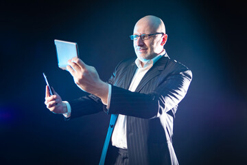 Poster - A man is happy, holding a smartphone and a tablet computer. Devices for communication and entertainment. Technology in modern life. Computer gadgets in everyday life.