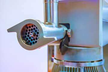 Kitchen appliances for cafes and restaurants. Industrial meat grinder close-up. Equipment for the manufacture of minced meat. Kitchen appliances made of stainless steel.