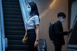 © torwaiphoto - Working woman she is at the subway. she wears a face shield and a virus mask.