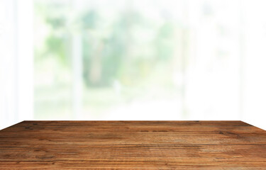 Poster - empty room with wooden floor table top, window with nature blurred for abstract background. 
