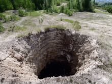 Huge Karst Sinkhole Leading To Abandoned Limestone Mine. Diameter Of Hole Is About 15-18 Feet, Depth About 75 Feet