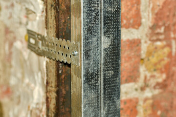 Fixing drywall profile to the wall, closeup.