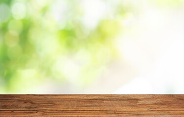 Poster - empty room with wooden floor table top, window with nature blurred for abstract background.