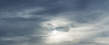 Panorama Of A Majestic Gray Sky With Sun Over Horizon. High Resolution, No Birds, No Noise. Sun Through Stormy Clouds.