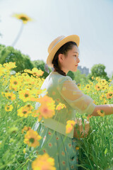 Daisies and girls with baskets in urban park in early summer