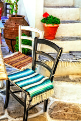 Wall Mural - Traditional Greece. Typical street taverns (bars) with cute wooden chairs.  Greece. Naxos island, Cycades.