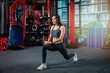 © Adulwit - Stretching before a great workout. Young beautiful Asian women in sportswear doing stretching body while standing in front of the window at the gym