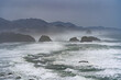 Canon Beach and Haystack Rock viewed from Ecola State park on a rainy winter day.