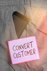 Poster - Text sign showing Convert Customer. Business photo showcasing marketing tactics and strategy turning leads into buyer Smartphone device inside formal work trousers front pocket near note paper