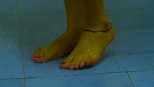 Young Beautiful Woman Taking A Shower In A Bathroom. Close-up Shot Of Female Legs.