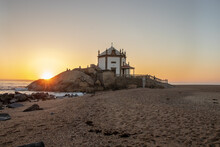 Beautiful Sunset At The Chapel Of Senhor Da Pedra Is Located In  Miramar Beach, District Of Porto , Portugal