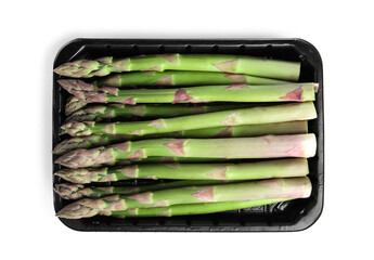 Fresh raw asparagus in plastic container isolated on white, top view