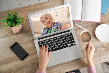 Poster - Young woman having video chat with her grandmother at home, top view