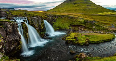 Wall Mural - Iceland time lapse video of waterfall and famous mountain. Kirkjufellsfoss and Kirkjufell in northern Iceland nature landscape. Amazing timelapse photography in 4K HDR.