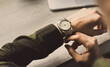 © panitan - fashionable wearing stylish looking at luxury watch on hand check the time at workplace.concept for managing time organization working,punctuality,appointment