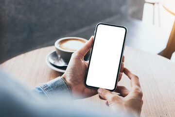 cell phone mockup image blank white screen.woman hand holding texting using mobile on desk at coffee shop.background empty space for advertise.work people contact marketing business,technology